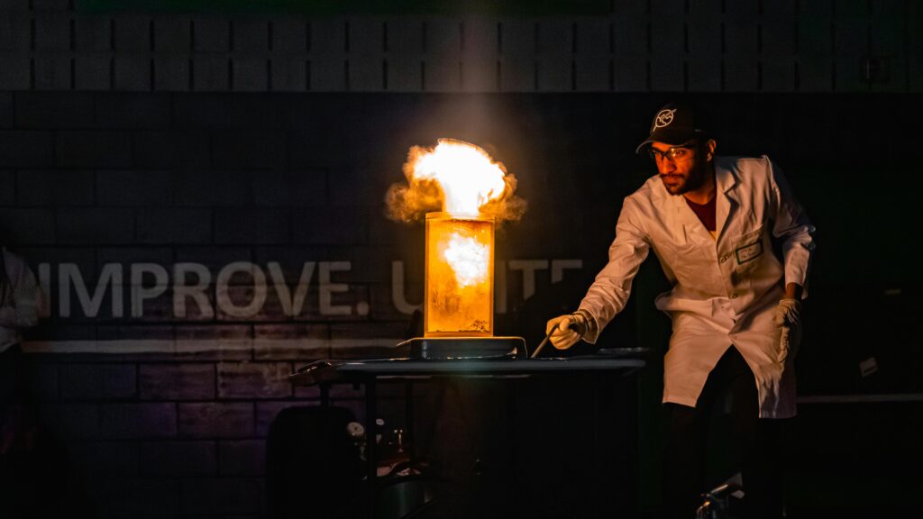 pexels photo 16653003 16653003 A scientist in a lab coat demonstrates a dramatic fire explosion experiment indoors.